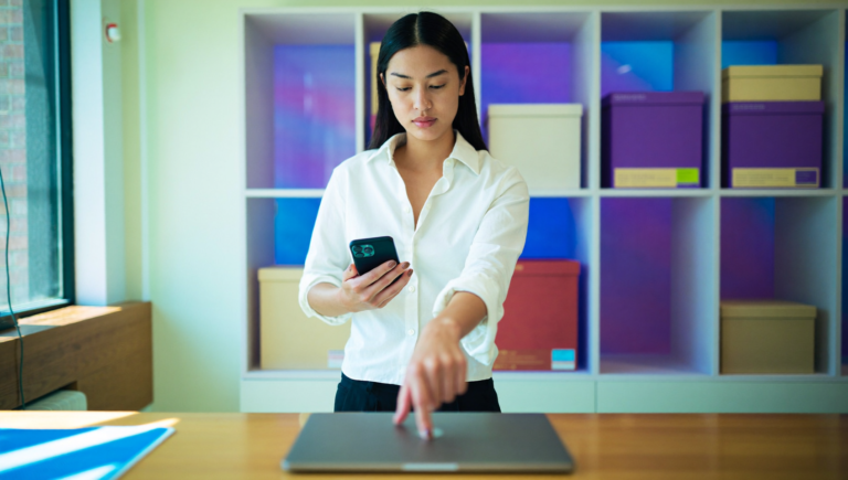 Une commerçante valide la passkey Merchant Center avec son empreinte sur un ordinateur portable